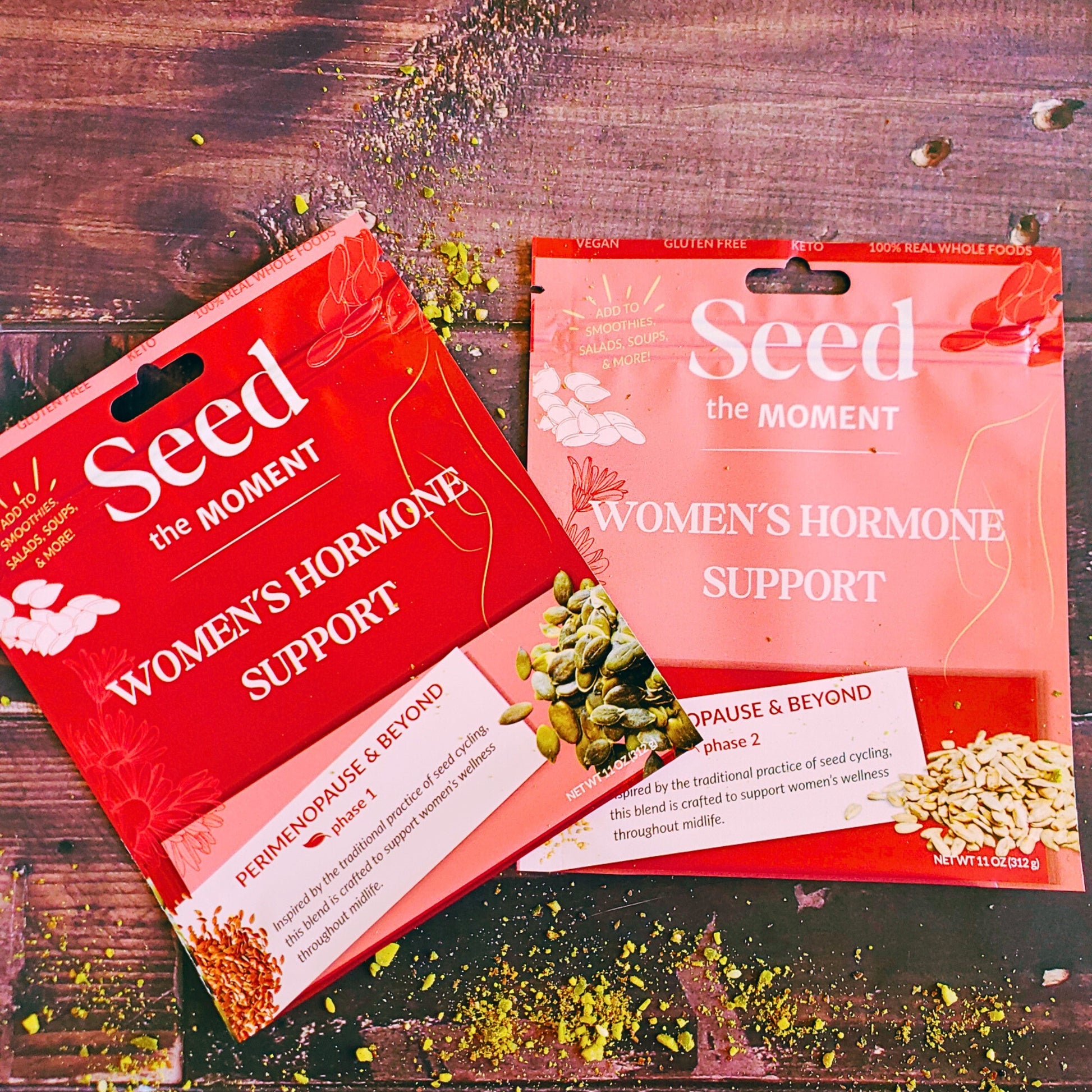 Two packages of 'Seed the Moment Women's Hormone Support' on a wooden surface.